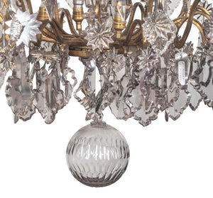 A 19th Century French Louis XV Style Crystal And Gilt Twelve-Light Chandelier