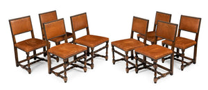 A SET OF EIGHT SPANISH WALNUT AND STUDDED LEATHER DINING CHAIRS