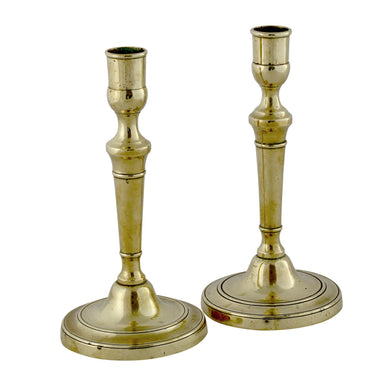 A PAIR OF GEORGE III BRASS CANDLESTICKS, LATE 18TH CENTURY